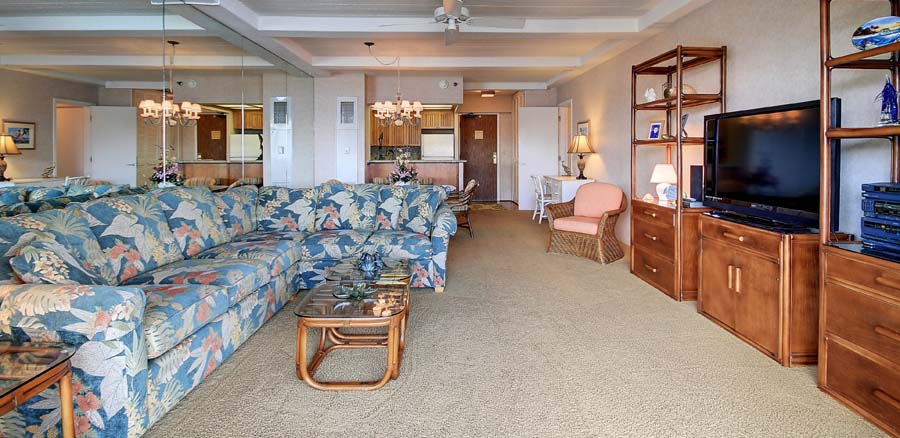 The living room of this one bedroom Hawaiian condo includes a new, large flat screen TV, queen sleeper and roll away for an additional daily cost.