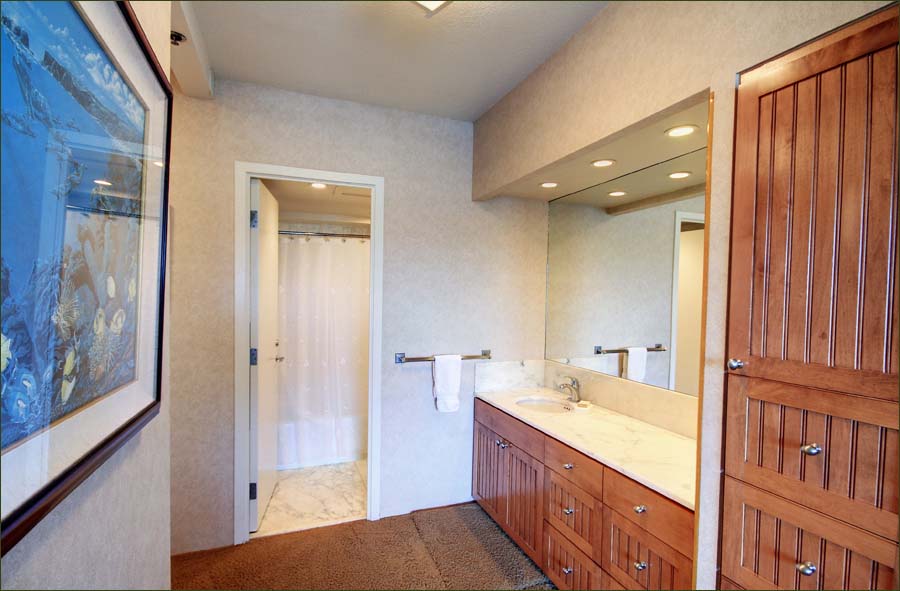 Master bedroom with large dressing, wardrobe area leading to the private bathroom.