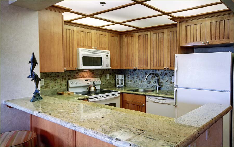 The Whaler #1156 kitchen with new appliances, granite countertops and views of the sea.