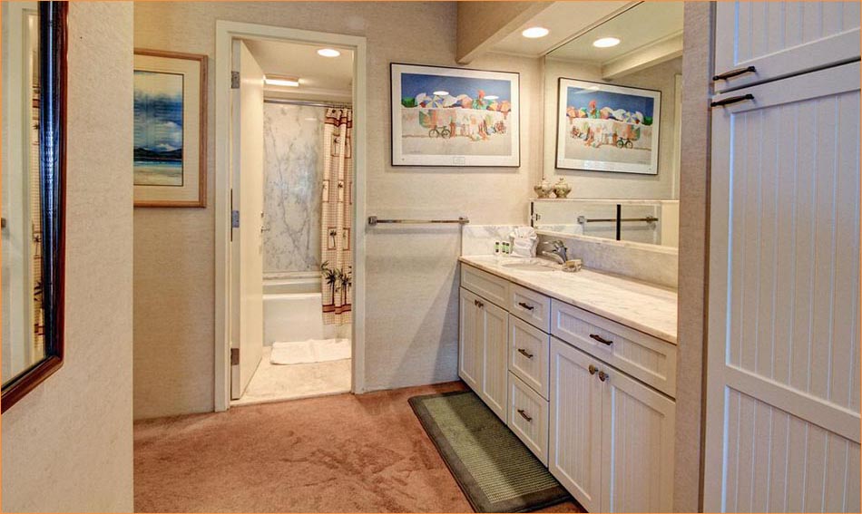The full master bathroom includes a personal dressing area.