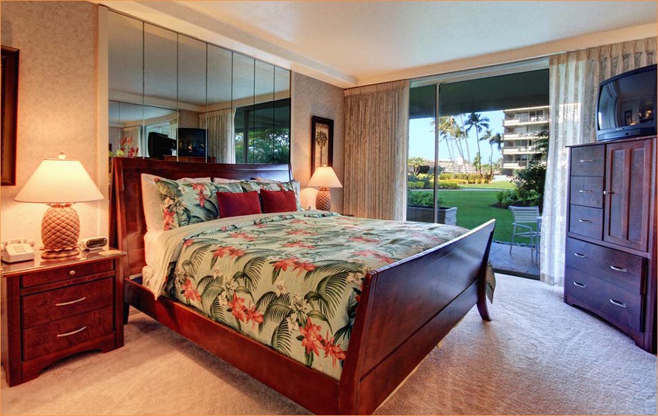 Colorful and well appointed master bedroom with king bed, en suite bathroom, private patio/lanai access.